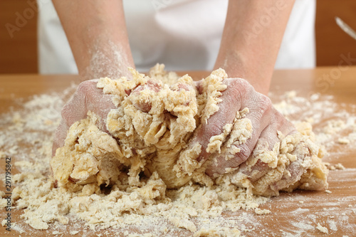 A baker kneading dough. Making Pastry Dough for Hungarian Cake. Series.