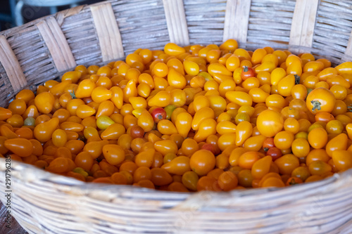 yellow tomato pear in a white basket