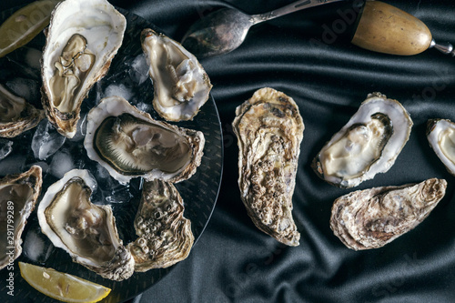 Open oysters on black cloth 