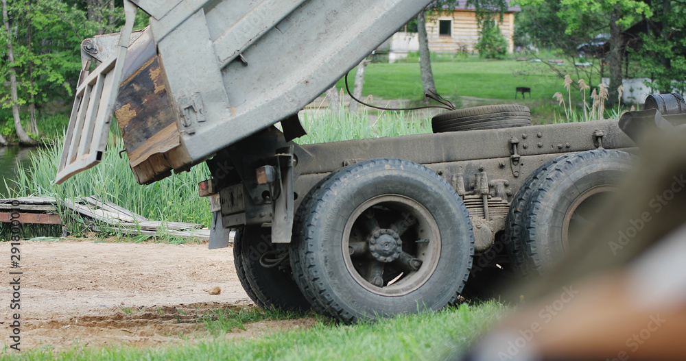 Close-up of a truck going along the shore of a lake. Construction. Close-up of a truck going along the shore of a lake. Construction.