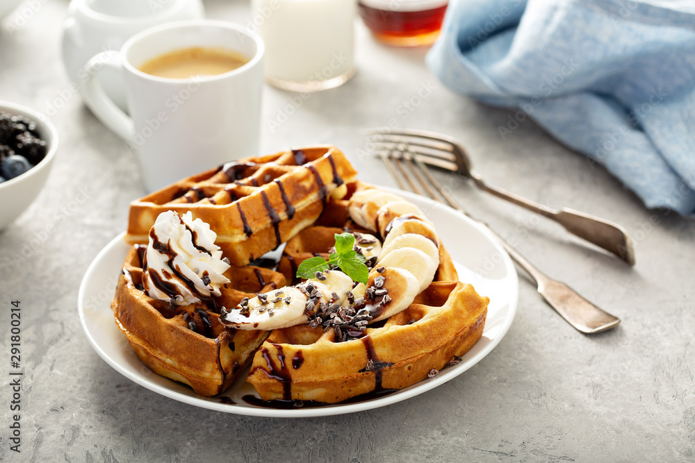 Fotografie Breakfast waffles with bananas and chocolate sauce