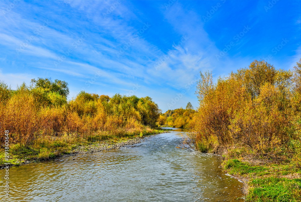 Idyllic bright multicolored autumn landscape with little fast forest river Idyllic bright multicolored autumn landscape with little fast forest river