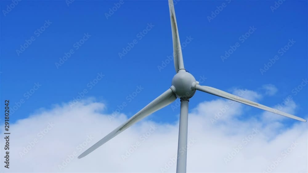 Close Up of Wind Turbine. Renewable energy at Eolic Park, Terceira Island, Azores. Blue sky in background with clouds. Slowmotion Close Up of Wind Turbine. Renewable energy at Eolic Park, Terceira Island, Azores. Blue sky in background with clouds. Slowmotion