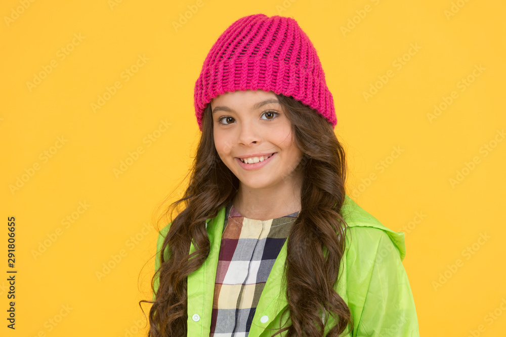 Winter hat styles. Kid girl wear knitted hat. Winter accessory concept. Girl long hair yellow background. Cold season concept. Winter fashion accessory. Small child wearing warm hat. Style guide Winter hat styles. Kid girl wear knitted hat. Winter accessory concept. Girl long hair yellow background. Cold season concept. Winter fashion accessory. Small child wearing warm hat. Style guide