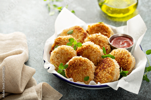 Chicken patties or fish cakes fried in breadcrumbs with ketchup