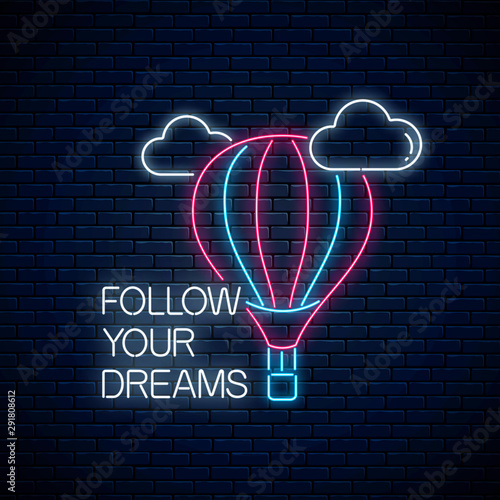 Follow your dreams - glowing neon inscription phrase with hot air balloon sign. Motivation quote in neon style.