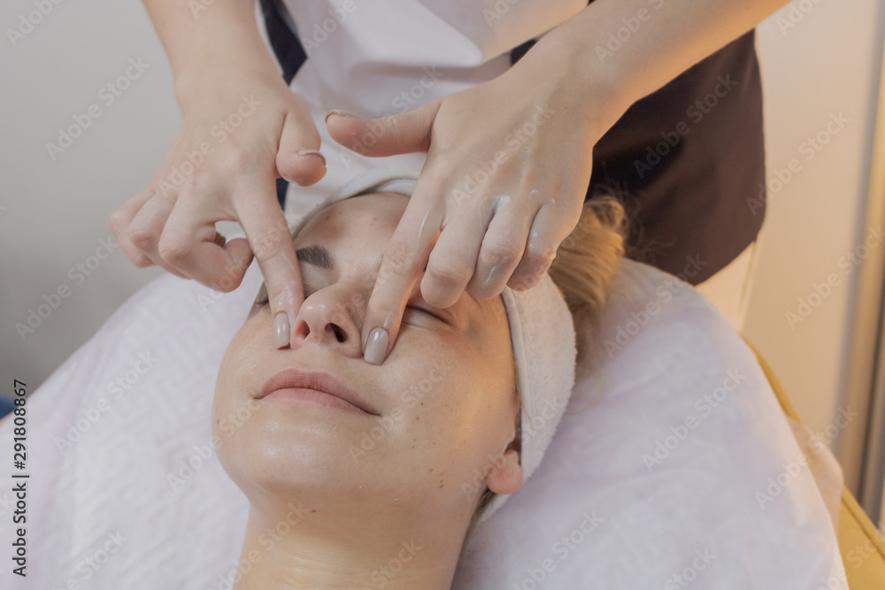 Professional beautician does the procedure for a woman in a beauty parlor. Professional beautician does the procedure for a woman in a beauty parlor.