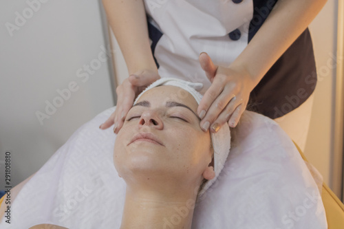 Professional beautician does the procedure for a woman in a beauty parlor.