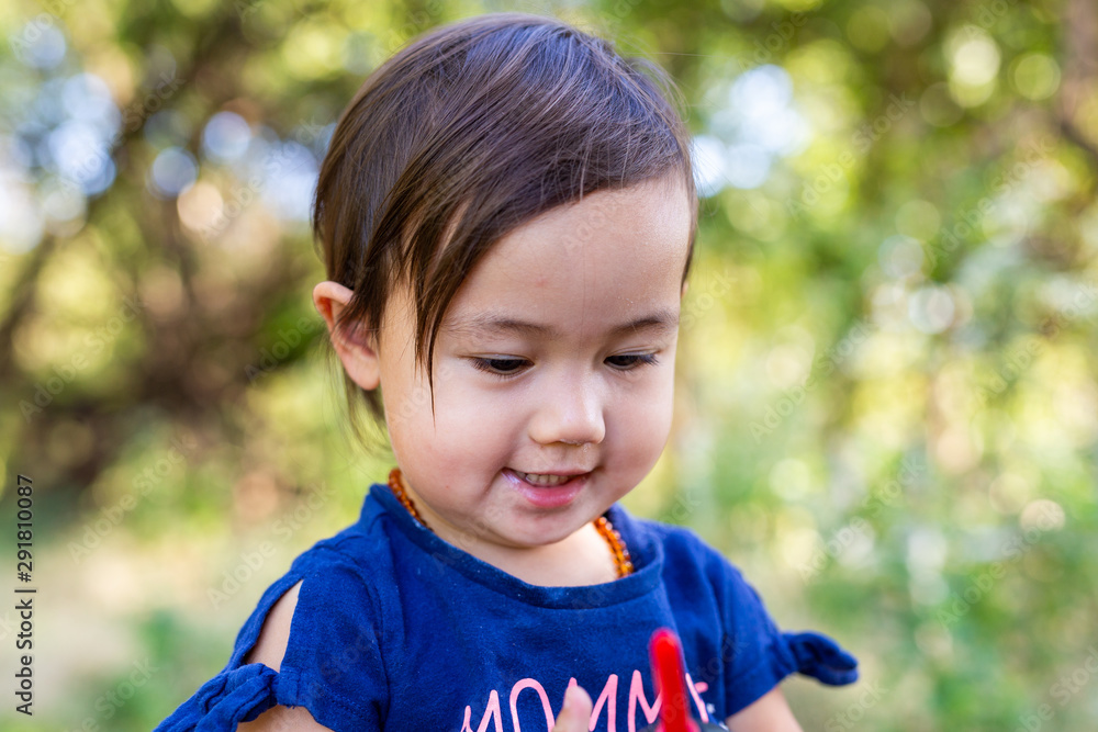 Toddler Girl Exploring Outdoors on Summer Day Toddler Girl Exploring Outdoors on Summer Day