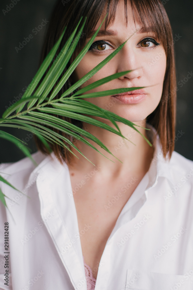 Woman hipster with tattoo posing witn fern leaf Woman hipster with tattoo posing witn fern leaf