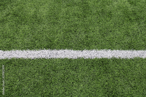 GREEN ARTIFICIAL FOOTBALL FIELD WITH A WHITE LINE