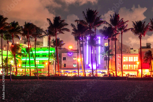 Miami Beach Ocean Drive hotels and restaurants at sunset. City skyline with palm trees at night. Art deco nightlife on South beach © Mariakray