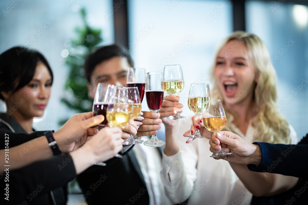 Toast to success. Group of business people toasting with champagne and smiling while standing close to each Toast to success. Group of business people toasting with champagne and smiling while standing close to each