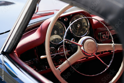 Vintage retro car interior, close-up. Old automobile steering wheel