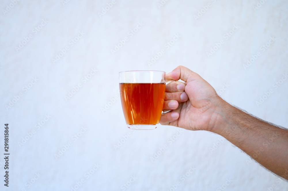 glass cup of tea in the male hand glass cup of tea in the male hand