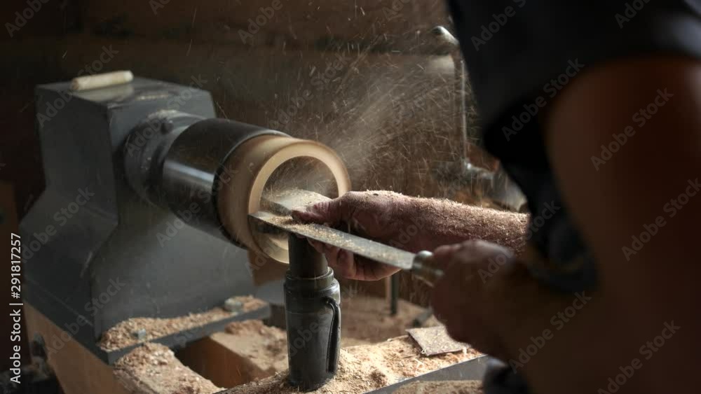 Wooden mug turning on lathe. Carpenter working with electric machine at workshop. Wood turning project. Wooden mug turning on lathe. Carpenter working with electric machine at workshop. Wood turning project.