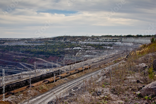 Freight train with ore in open mining quarry