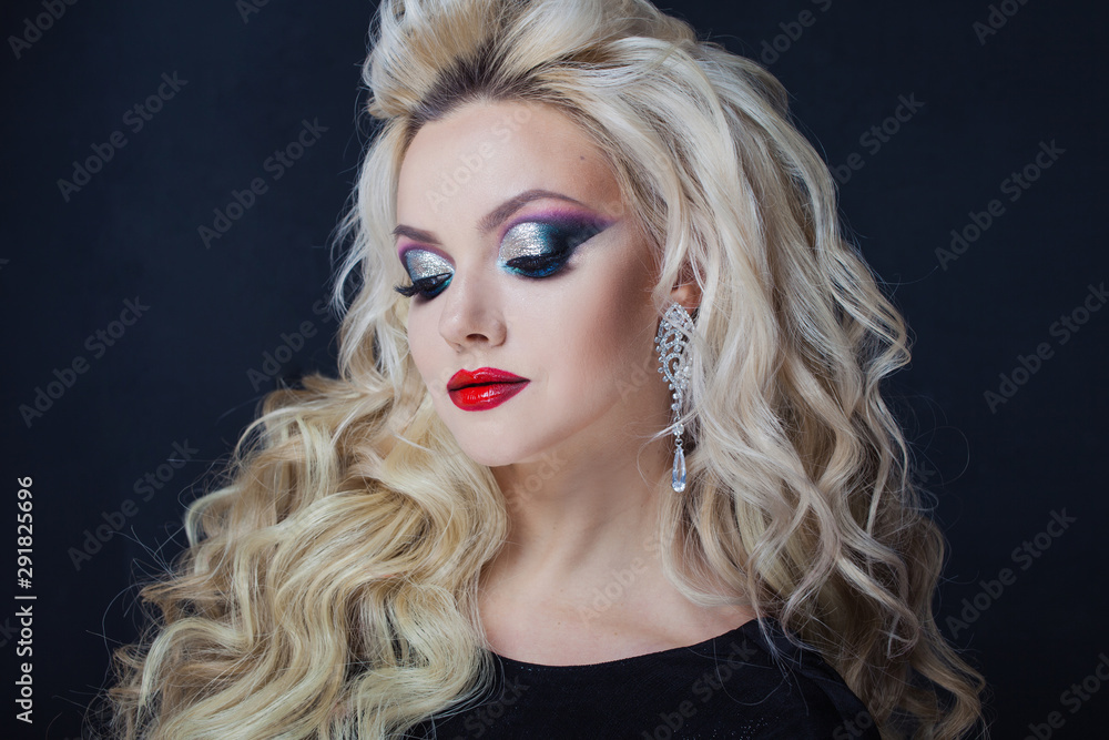 Portrait of a young luxurious blonde with long curls. Portrait of a young luxurious blonde with long curls.