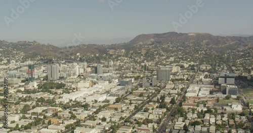 Aerial shot, day, view of hollywood neighborhood and hollywood sign at distance, drone