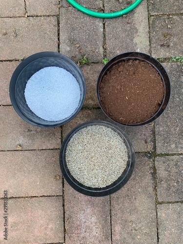 Three pots containing perlite, vermiculite and peat moss, with are intended to create a potting mix