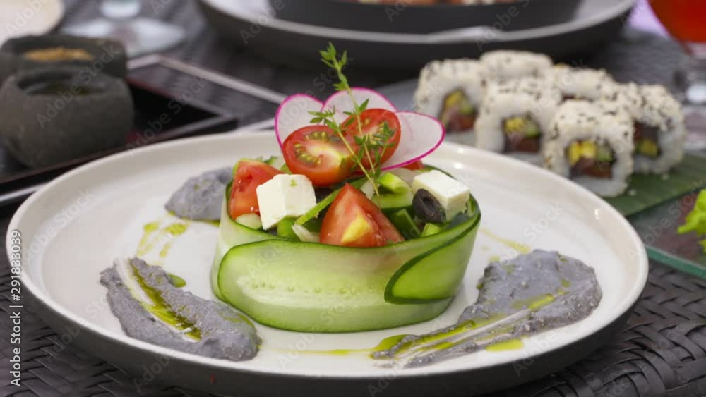 Close up of a salad dish wrapped inside a cucumber roll Close up of a salad dish wrapped inside a cucumber roll
