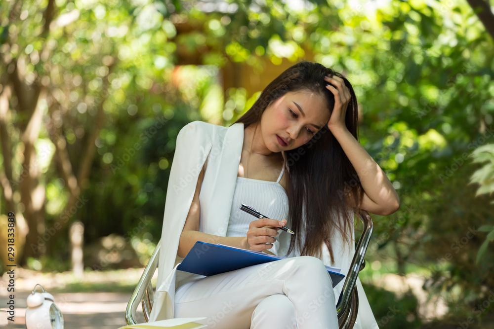 Beautiful business woman sit and work in the garden, Beautiful business woman sit and work in the garden,