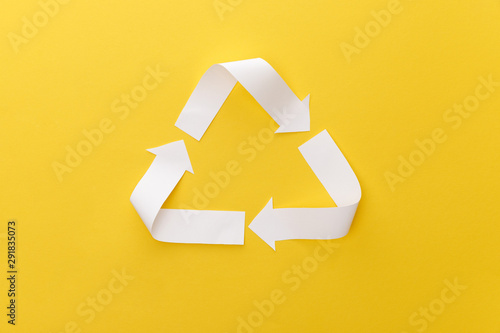 top view of paper craft triangle on yellow background