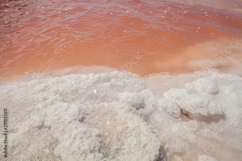 Pink waters during the evaporation process of seawater in the production of table salt. Macau Saline on the coast of Rio Grande do Norte-Brazil, producers of sea salt.