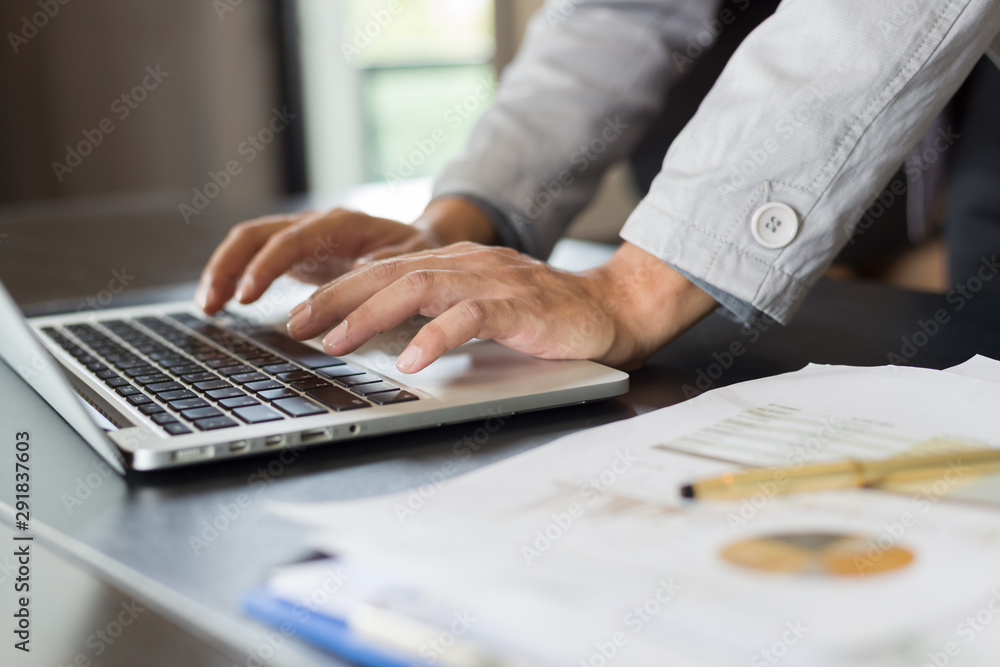 Fototapeta premium Asian businessman of analysis documents on office table with laptop computer 