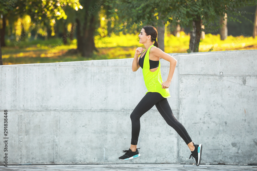 Fototapeta premium Sporty young woman running outdoors