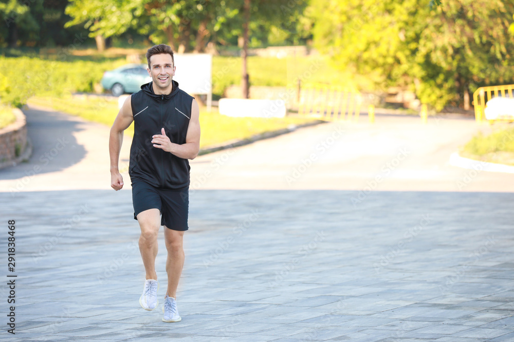 Sporty young man running outdoors Sporty young man running outdoors