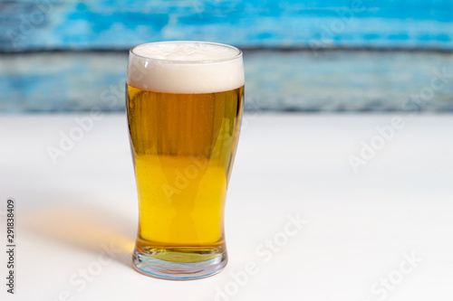 glass of beer on wooden background