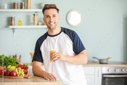 Handsome man drinking juice...