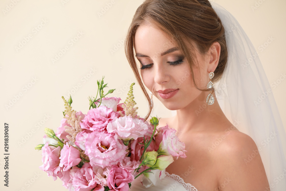 Portrait of beautiful young bride with wedding bouquet on light background Portrait of beautiful young bride with wedding bouquet on light background