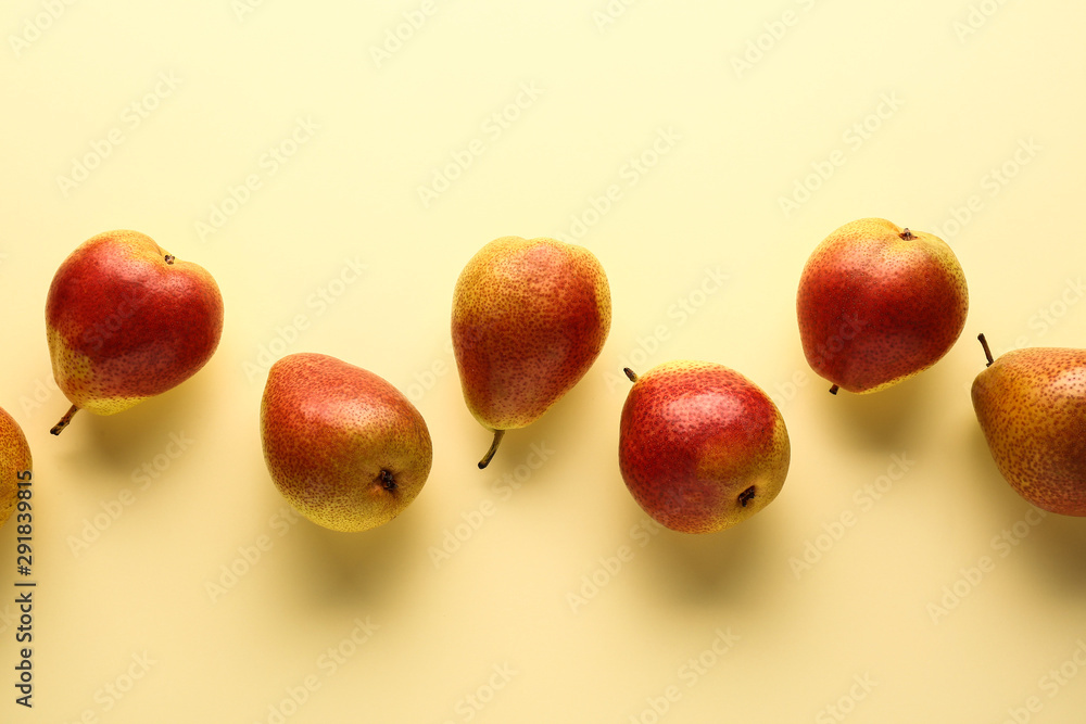 Fototapeta premium Sweet ripe pears on color background