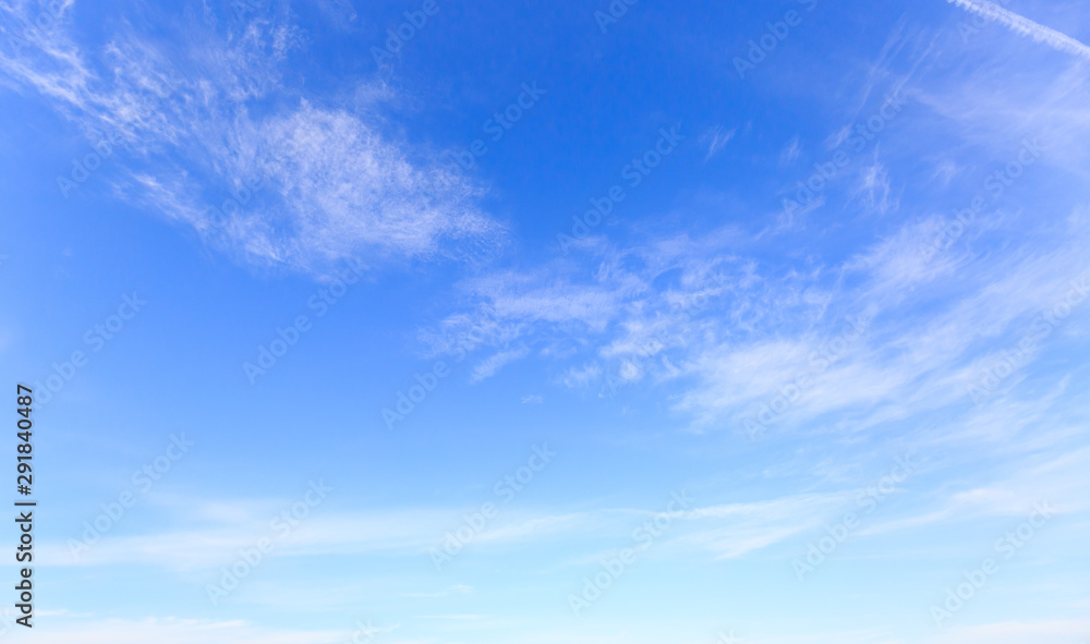blue sky with fluffy wispy clouds