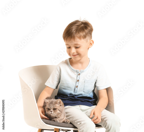 Happy young boy sitting on ...