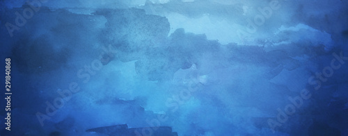 Blue watercolor background with texture and paint bleed, with light center and dark borders in abstract painted cloudy sky design