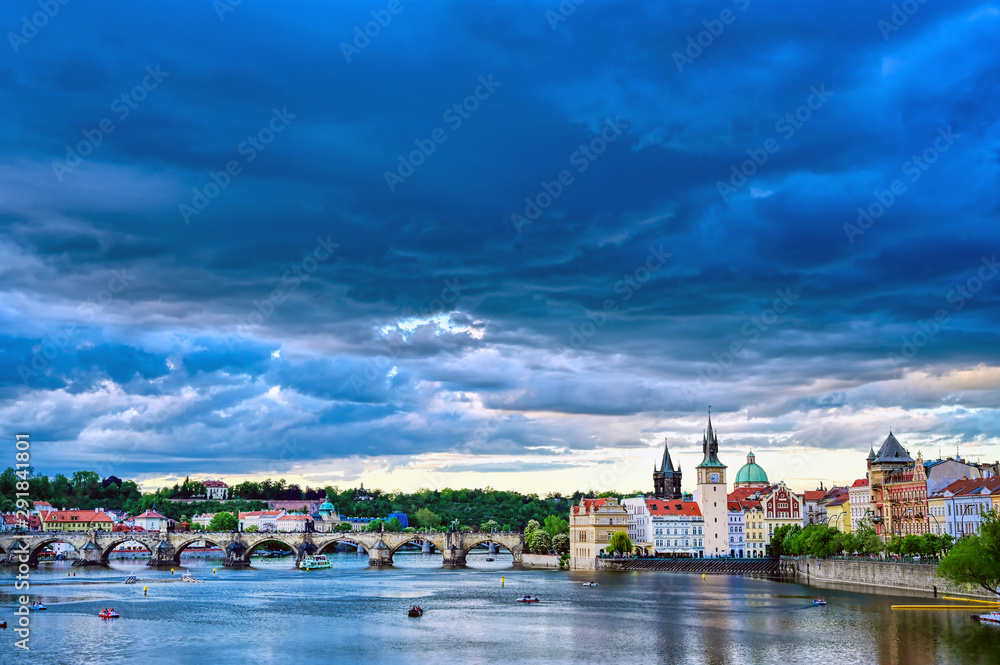 Obraz premium A view of Old Town Prague and the Charles Bridge across the Vltava River in Prague, Czech Republic.