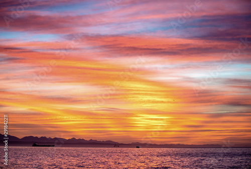 Seascape. Clouds  red sunrise sky  Mossel bay. South Africa.