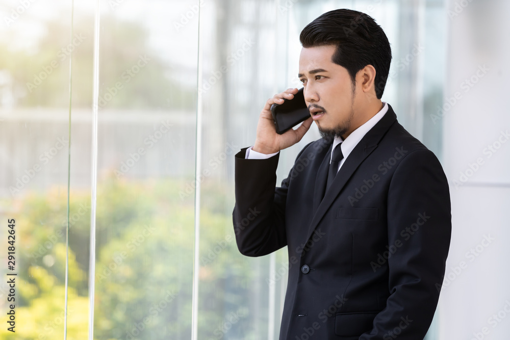 business man talking with mobile phone in office business man talking with mobile phone in office