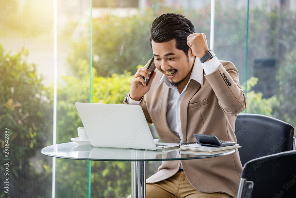 happy business man talking on mobile phone and using laptop happy business man talking on mobile phone and using laptop