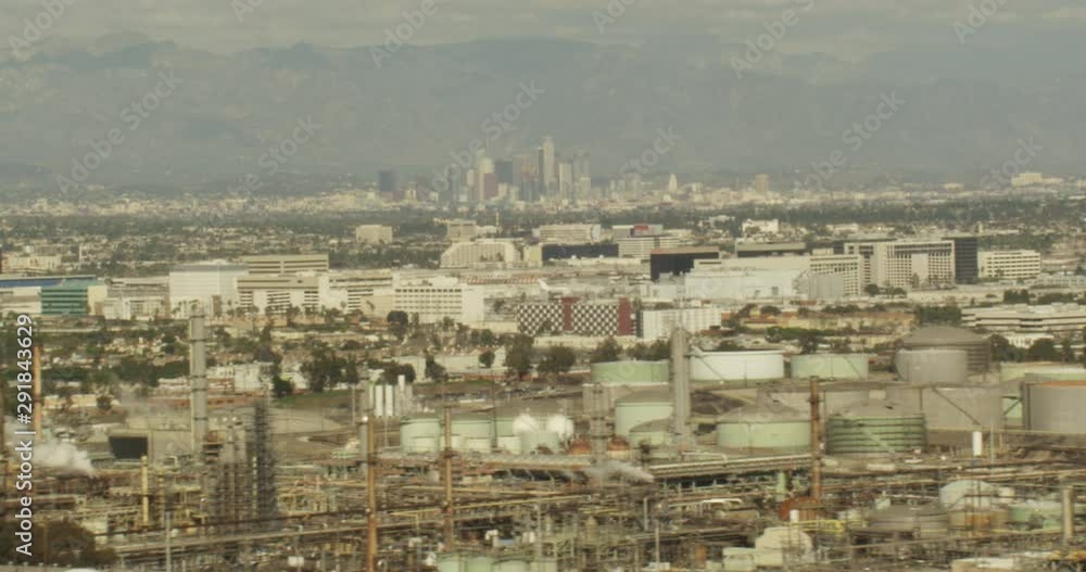 Aerial shot, day, view of industrial area with Downtown LA and planes in far distance, drone Aerial shot, day, view of industrial area with Downtown LA and planes in far distance, drone