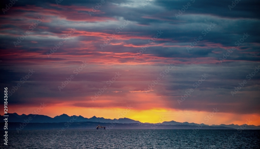 Seascape. Clouds, red sunrise sky, Mossel bay. South Africa.