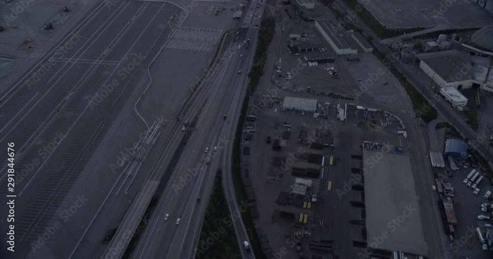 Aerial shot, low light, follow highway traffic into Los Angeles shipping port, drone Aerial shot, low light, follow highway traffic into Los Angeles shipping port, drone