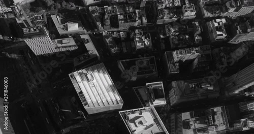 Black and white aerial shot, top-down view of NYC building roofs, drone