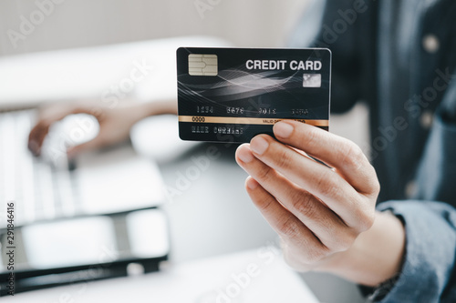 beautiful Woman showing credit card and smartphone before shopping website online, shopping concept
