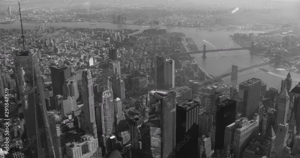 Black and white aerial shot, pan over financial district , One World Trade center left-focused, drone