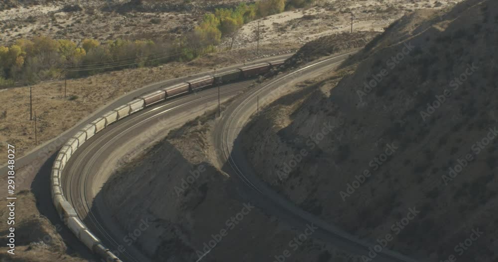 Helicopter aerial shot of extremely long train passing through mountainside, Helicopter aerial shot of extremely long train passing through mountainside,