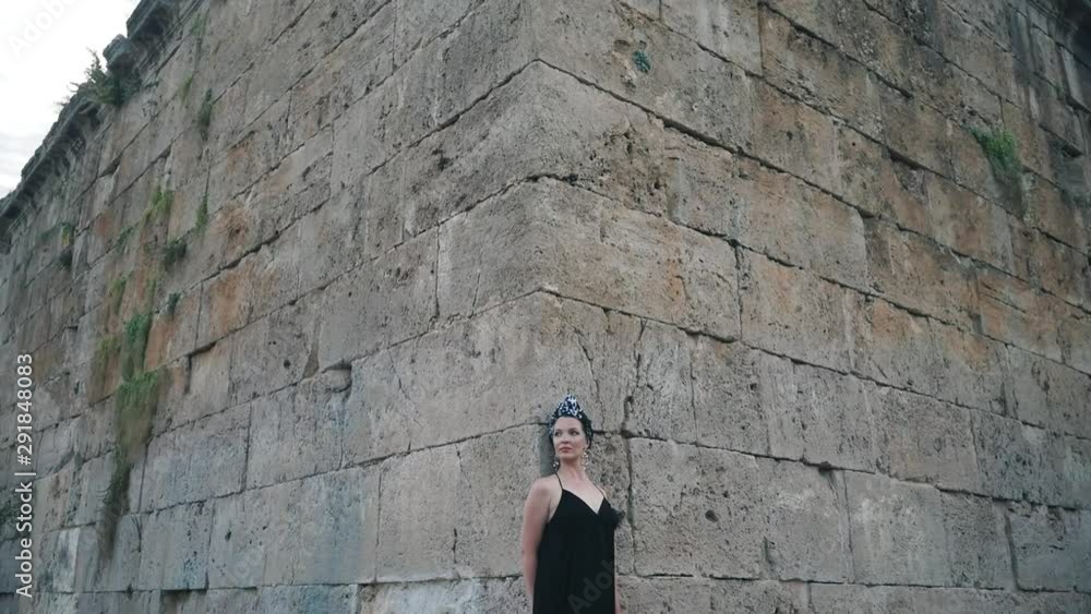 Beautiful young attractive Muslim woman in long black dress standing on the corner of Hidirlik tower, historical place Beautiful young attractive Muslim woman in long black dress standing on the corner of Hidirlik tower, historical place